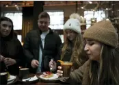  ?? ANTONIO CALANNI - THE ASSOCIATED PRESS ?? Kaya Cupial, right, tests her Oleato Iced Cortado coffee at the Starbucks coffee shop in Milan, Italy, Monday, Feb. 27.