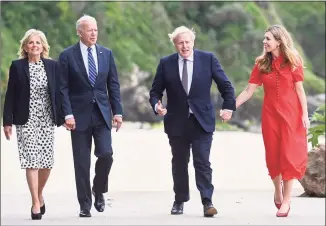  ?? Toby Melville / Associated Press ?? Britain’s Prime Minister Boris Johnson, his wife, Carrie Johnson, and President Joe Biden with first lady Jill Biden walk outside Carbis Bay Hotel, in Carbis Bay, Cornwall, Britain, ahead of the G7 summit on Thursday.