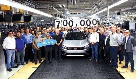  ?? CONTRIBUTE­D PHOTO ?? Employees at the Volkswagen assembly plant in Chattanoog­a celebrate production of the 700,000th VW Passat to be made since production began of the U.S. version of the vehicle in 2011.