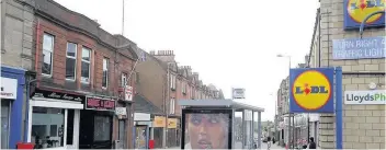  ??  ?? Main Street Was the scene of incidents involving several youths in flats above shops in Wishaw Main Street