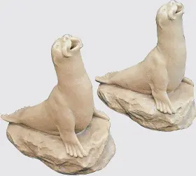  ??  ?? FLIPPER FLOW: A pair of Leeds Fireclay Company seal fountains which realised £1,680 at Catherine Southon of Chislehurs­t; inset, the Mouseman mouse which went for a surprise £7,200 at Tennants.