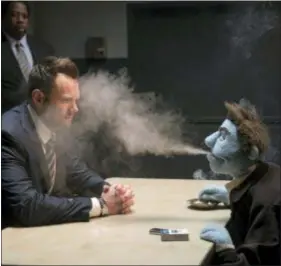  ?? STX ENTERTAINM­ENT ?? Puppet Phil (Bill Barretta) blows smoke in the face of an FBI agent portrayed by Joel McHale.