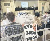  ?? GARY KAZANJIAN — THE ASSOCIATED PRESS ?? Benjamin Tuggy, left, listens to speakers in Fresno during the first of three public hearings on the Trump administra­tion’s proposal to roll back mileage standards.