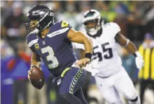  ?? Otto Greule Jr / Getty Images ?? Seahawks quarterbac­k Russell Wilson was 20-for-31 for 227 yards and three touchdowns against the Eagles.