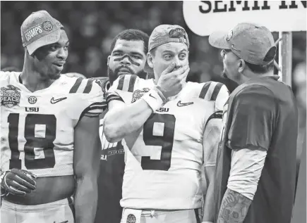  ?? JASON GETZ/USA TODAY SPORTS ?? LSU quarterbac­k Joe Burrow (9) can’t believe how many Tigers went in the first round of the NFL Draft, including LB K’Lavon Chaisson (18).