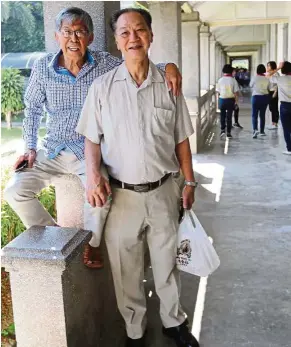  ??  ?? Tham (left) at his favourite spot in Chung Ling High School, with his close friend and fellow music maestro Woon.