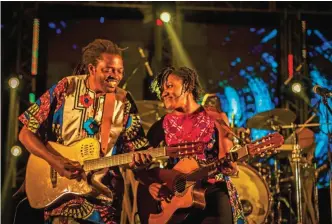 ??  ?? Cameroonia­n artist Kareyce Fotso, right, performs with her band at the Harare Internatio­nal Festival of the Arts (HIFA) in Zimbabwe.
