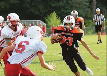  ??  ?? LaFayette's Jalen Suttle looks for room to run as Sadde Ridge defenders Chris Bell (6) and Gabe Kirkendoll (75) close in. (Photo by Keith Deal)