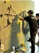  ??  ?? Participan­ts create their murals during the Axe You event.