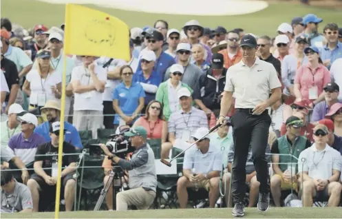  ??  ?? Rory Mcilroy reacts to a putt on the 18th green during yesterday’s round of 71, which moved him into the clubhouse lead at Augusta.