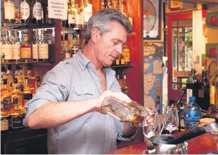  ?? Pictures: Gallo Images ?? TASTING TIME. Steve Adams is one of the co-owners of Wild about Whisky. It’s not just a great place to learn more about whisky, but also a cosy bar with a fireplace.