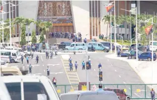  ?? — AFP ?? Papua New Guinea police and soldiers (C) are pictured outside the parliament in Port Moresby.