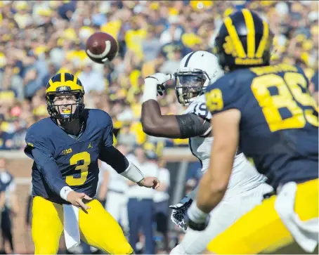  ?? TONY DING/THE ASSOCIATED PRESS ?? Michigan quarterbac­k Wilton Speight, left, leads the Wolverines into a showdown with Wisconsin on Saturday in a battle of Big Ten unbeatens.