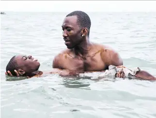  ?? DAVID BORNFRIEND/A24 ?? Alex Hibbert and Mahershala Ali star in Moonlight, which writer-director Barry Jenkins hopes challenges viewers to contemplat­e new perspectiv­es and different people.