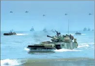  ?? DUAN HONGWEI / FOR CHINA DAILY ?? Right: The PLA Ground Force makes an amphibious landing during exercises in 2016.