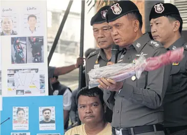  ??  ?? Jiraphan Koisap, 36, a suspect who allegedly confessed to attacking a boxing judge at Lumpini Boxing Stadium, is taken to a news conference at Bang Khen police station.