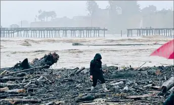  ?? Josh Edelson AFP/Getty Images ?? THE WHARF in Capitola, Calif., is split in half. Joshua Fisher, a property manager in the city’s downtown, said the high surf pushed the swollen San Lorenzo River’s waters — and debris — into the streets.