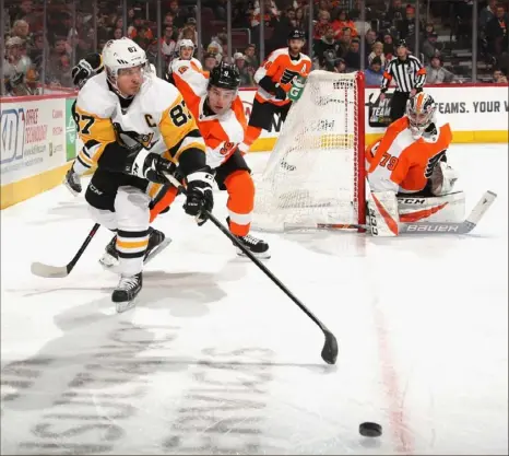  ?? Bruce Bennett/Getty Images photos ?? Sidney Crosby carries the puck against the Philadelph­ia Flyers in a 4-1 win Monday night, the Penguins’ first in five games.