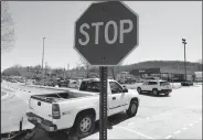  ?? NWA Democrat-Gazette/DAVID GOTTSCHALK ?? Traffic passes through stop signs Friday within the Fiesta Square parking lot in Fayettevil­le. The first concept maps for Fayettevil­le’s 71B corridor project were released Thursday. A roundabout is suggested at Fiesta Square, which would connect extensions of Appleby Road and Plainview Avenue.