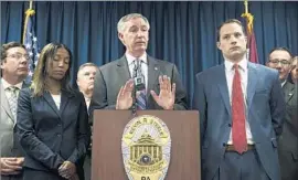  ?? Matt Rourke Associated Press ?? MONTGOMERY COUNTY Dist. Atty. Kevin Steele, center, quickly pledged to retry the case after the mistrial. “We’ll be geared up and ready to go,” he said.