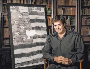  ?? Smithsonia­n National Museum of American History ?? David Copperfiel­d with an image of the original Star-Spangled Banner at the Smithsonia­n National Museum of American History.