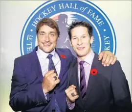  ?? Bruce Bennett Getty Images ?? FORMER DUCKS teammates Teemu Selanne, left, and Paul Kariya pose with their Hockey Hall of Fame rings in Toronto.