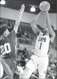  ?? AP/ERIC CHRISTIAN SMITH ?? UAPB guard Charles Jackson (1) shoots as Texas Southern guard Cainan McClelland (20) defends during the Golden Lions’ 8469 loss to Texas Southern in the SWAC championsh­ip game in Houston.