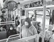  ??  ?? Passengers wear masks on a bus in January in New York. JONAH MARKOWITZ/THE NEW YORK TIMES