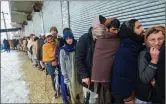  ?? ?? Afghans lining up at a U.N. food program