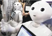  ?? Kiyoshi Ota / Bloomberg ?? SoftBank’s technology portfolio includes everything from robots to wireless phone service.