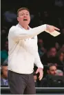  ?? ELSA/GETTY ?? Mark Byington, shown Sunday coaching James Madison during its first NCAA Tournament since 2013, is heading to Vanderbilt. His Dukes were 32-4 this season and reached the NCAA’s round of 32.