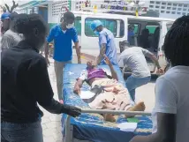  ??  ?? A man injured in the earthquake is transferre­d from the general hospital in Les Cayes, Haiti. Photo / AP