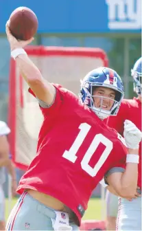  ?? JOHN KRYK ?? Veteran quarterbac­k Eli Manning throws during New York Giants training camp on Sunday in East Rutherford, N.J. Manning will be pressured for the starting job by rookie Daniel Jones this season.
