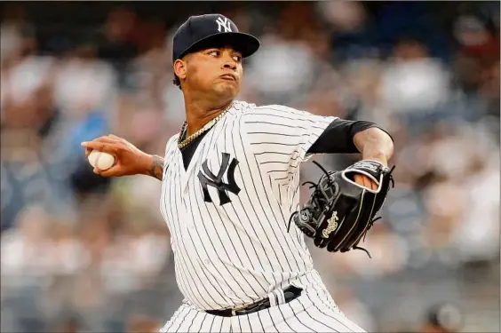  ?? Photos by Adam Hunger / Getty Images ?? New York’s Luis Gil is the only major league pitcher since at least 1901 with no runs allowed and 15 or more strikeouts through his first three games. He allowed three hits and four walks and struck out four over 42⁄3 innings on Tuesday night at Yankee Stadium.