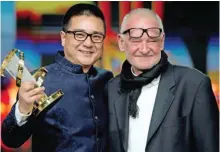  ??  ?? Chinese director Zang Qi Wu receives his award from Hungarian director Bela Tarr during the awards ceremony of the 14th edition of the Marrakech Internatio­nal Film festival in Marrakech. — AFP photos