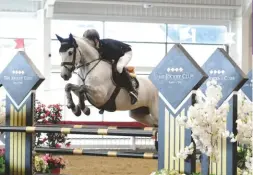  ??  ?? The eight-year-old Clyde Barrows sails into the lead in the pony newcomers final with Henry Squibb, showing effortless scope