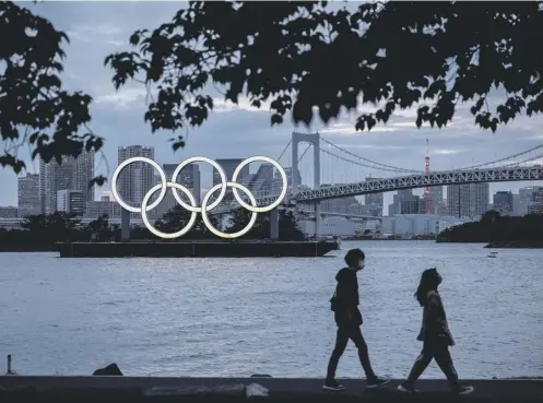  ??  ?? 0 The Olympic rings at dusk on the Odaiba waterfront in Tokyo. Vaccines will now be available to athletes and staff before the Games