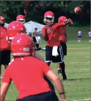  ?? LARRY GREESON / For the Calhoun Times ?? Sonoravill­e quarterbac­k Patrick Moore (right) follows through on a pass during camp on Wednesday.