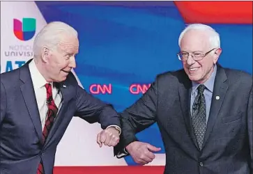  ?? Mandel Ngan AFP/Getty Images ?? JOE BIDEN and Bernie Sanders at a debate last month. With Sanders dropping out, Biden is seeking to win over his rival’s band of progressiv­e supporters, many of whom lack enthusiasm for the former vice president.
