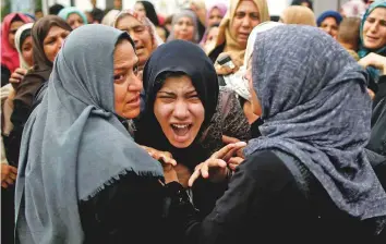  ?? Reuters ?? A relative of Palestinia­n Naji Al Za’aneen, who was killed in an Israeli regime air strike, reacts during his funeral in the northern Gaza Strip yesterday.