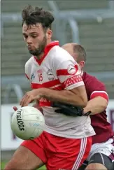  ??  ?? Conor Devitt beats Mark Maloney to the ball.