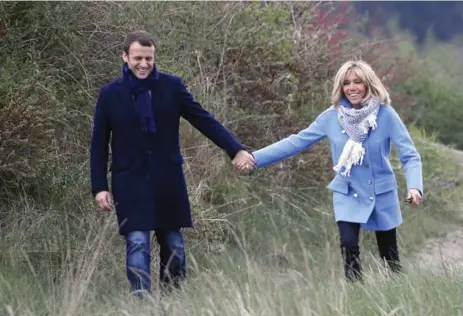  ?? CHESNOT/GETTY IMAGES FILE PHOTO ?? Emmanuel Macron and his wife, Brigitte. Ahead of election day, many women said they were more interested in Macron as his marriage flips a cliché.