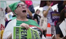  ?? ?? People hold signs as they gather for the Women's March in Washington on Saturday