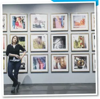  ??  ?? Photograph­er Marjolaine Ryley with her work on display. Picture: DAVID WOOD.