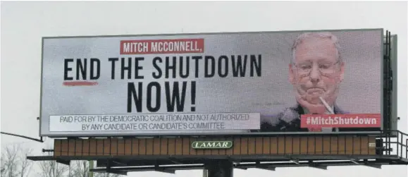  ??  ?? An electronic billboard, sponsored by the Democratic Coalition, shown Saturday, January 12, 2019 in Nicholasvi­lle, Ky. Mcconnell, who is up for re-election in 2020 in a state where Trump tends to be more popular than he is, sees no other choice than to stand back and let the president who took the country into the shutdown decide how he wants to get out of it.