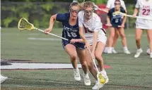  ?? Dave Stewart/Hearst Connecticu­t Media ?? New Canaan's Maddie Tully, right, scoops up a ground ball with Wilton's Bel DiNanno in pursuit.