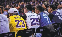  ?? AFP / Getty Images ?? Chinese fans watch a preseason game between the Dallas Mavericks and the Philadelph­ia 76ers in Shenzhen on Monday.