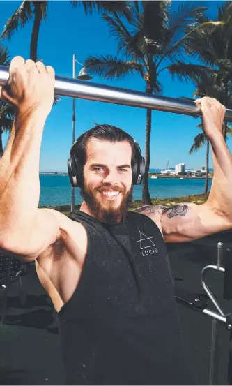  ?? PUMPED: James Fallon, of Bushland Beach, wears the Sennheiser headphones while working out on The Strand yesterday. Picture: ZAK SIMMONDS ??