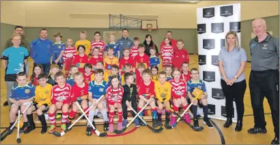  ??  ?? Youngsters at the recent Lochaber area primary five and under shinty festival with Jayne MacKay, personal assistant to the managing director of Marine Harvest, and Willie MacDonald, Camanachd Associatio­n youth director.