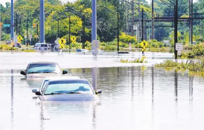  ?? MATT ROURKE/AP ?? Vehicles are under water during flooding in Norristown, Pa., on Sept. 2 in the aftermath of downpours and high winds from the remnants of Hurricane Ida that hit the area.